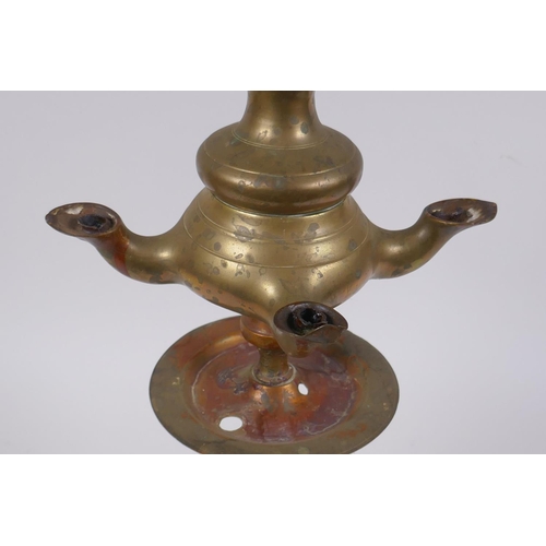 131 - An antique brass four spout whale oil lamp, 65cm high