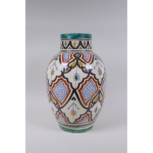 134 - A North African hand painted terracotta vase, signed to the base, 34cm high