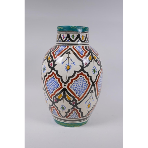 134 - A North African hand painted terracotta vase, signed to the base, 34cm high