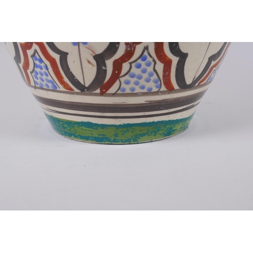 134 - A North African hand painted terracotta vase, signed to the base, 34cm high