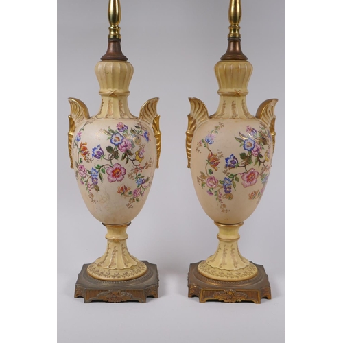 144 - A pair of continental porcelain urn shaped table lamps with gilt metal mounts and polychrome floral ... 