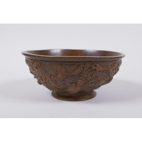 145 - A Chinese bronze trinket bowl with raised dragon decoration, Qianlong 4 character mark to base, 11cm... 