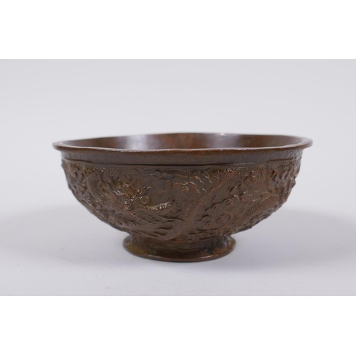 145 - A Chinese bronze trinket bowl with raised dragon decoration, Qianlong 4 character mark to base, 11cm... 