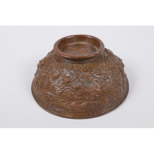 145 - A Chinese bronze trinket bowl with raised dragon decoration, Qianlong 4 character mark to base, 11cm... 