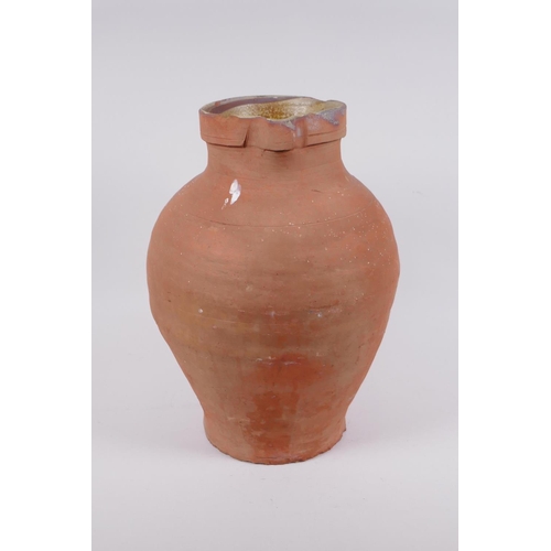 154 - An antique terracotta jug, AF chips