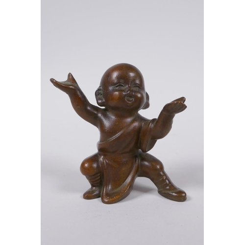 160 - An oriental bronze figure of a child monk, 8cm high