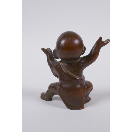 160 - An oriental bronze figure of a child monk, 8cm high