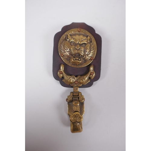 163 - A Chinese leather and bronze buckle with tiger and carp decoration, inscription verso, 13cm