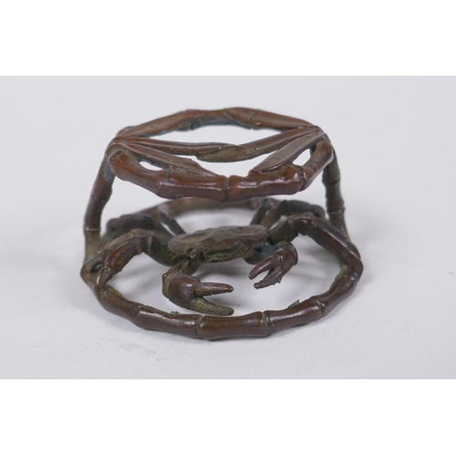 166 - An oriental bronze bamboo style stand with a crab, 6cm diameter