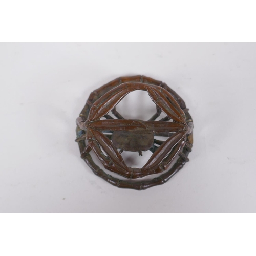 166 - An oriental bronze bamboo style stand with a crab, 6cm diameter