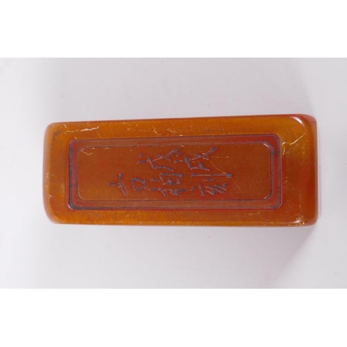 168 - A Chinese amber soapstone box containing a seal, the cover with ripple decoration and character insc... 