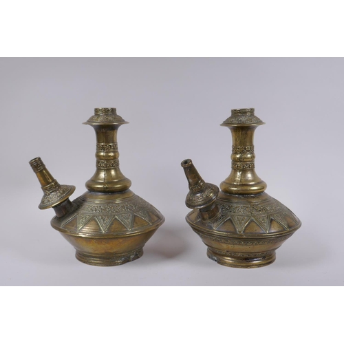 169 - A pair of Indo Persian bronze hookah pipes with raised floral decoration, AF, 25cm high