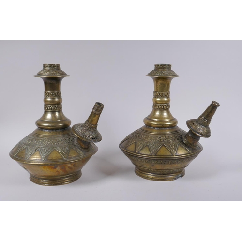 169 - A pair of Indo Persian bronze hookah pipes with raised floral decoration, AF, 25cm high