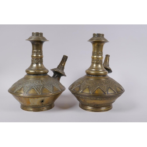 169 - A pair of Indo Persian bronze hookah pipes with raised floral decoration, AF, 25cm high