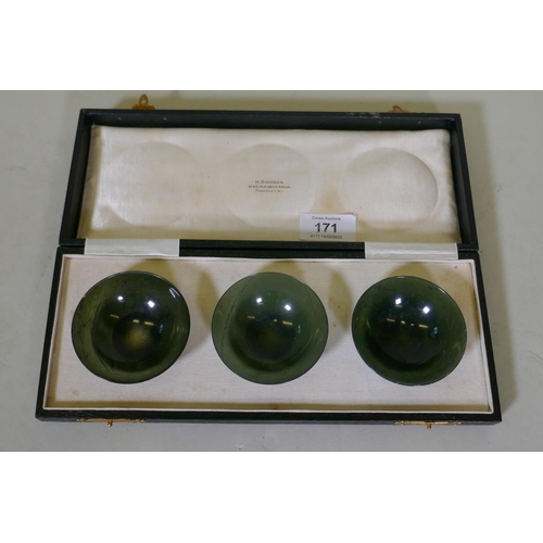 171 - A set of three spinach jade bowls in a presentation case inscribed H. Simmons, 60 & 61 Burlingto... 