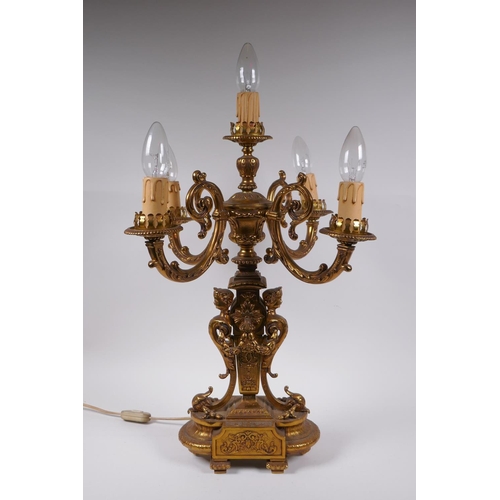 174 - A gilt bronze four branch candelabra decorated with cherubic busts and swags, 56cm high