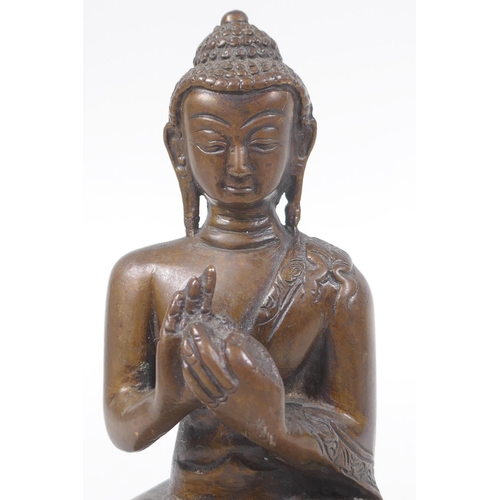 176 - A Sino Tibetan filled bronze figure of Buddha seated on a lotus throne, mark to base, 14cm high