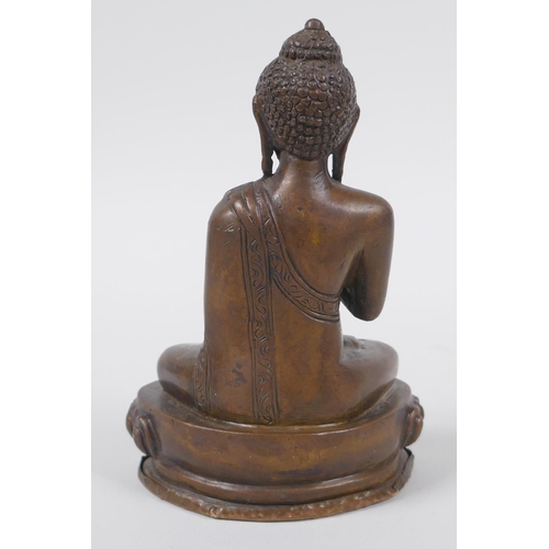 176 - A Sino Tibetan filled bronze figure of Buddha seated on a lotus throne, mark to base, 14cm high