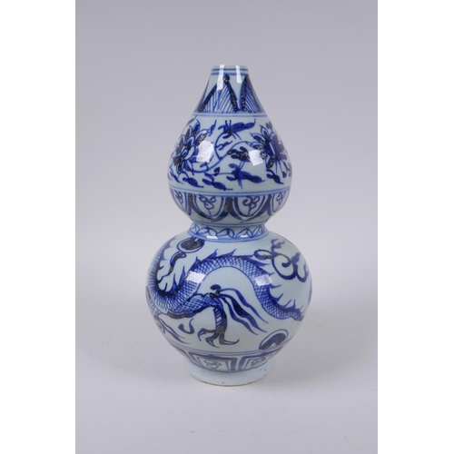 178 - A Chinese blue and white porcelain double gourd vase with dragon and flower decoration, 26cm high