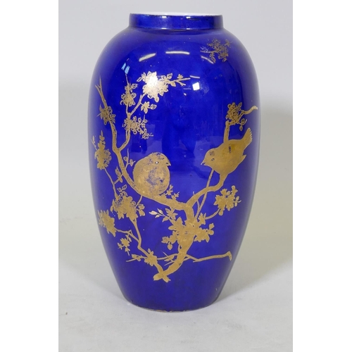 181 - A Carltonware vase with gilt and enamel decoration on a blue glaze, 27cm high