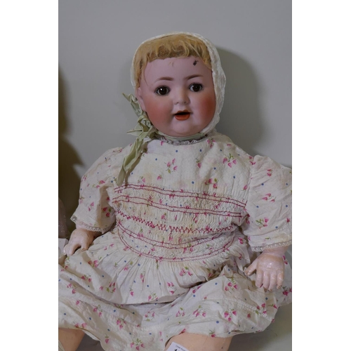 187 - A German Burgrubb porcelain head doll, with composition body and rolling brown eyes, marked 169, 64c... 