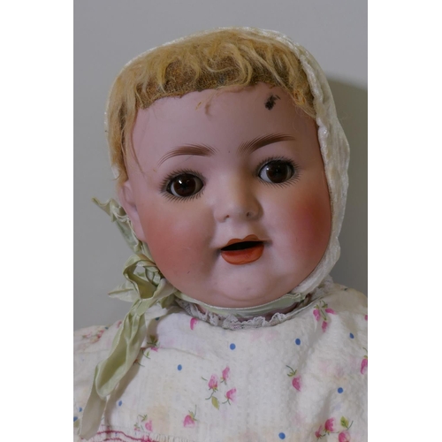 187 - A German Burgrubb porcelain head doll, with composition body and rolling brown eyes, marked 169, 64c... 