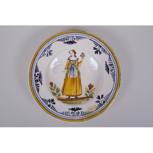 192 - An C18th Italian majolica dish decorated with a lady in yellow, label to base, 23cm diameter