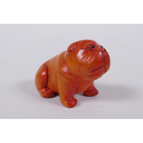 193 - A Japanese carved boxwood netsuke in the form of a puppy, mark to base, 6cm long