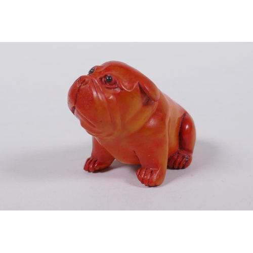 193 - A Japanese carved boxwood netsuke in the form of a puppy, mark to base, 6cm long