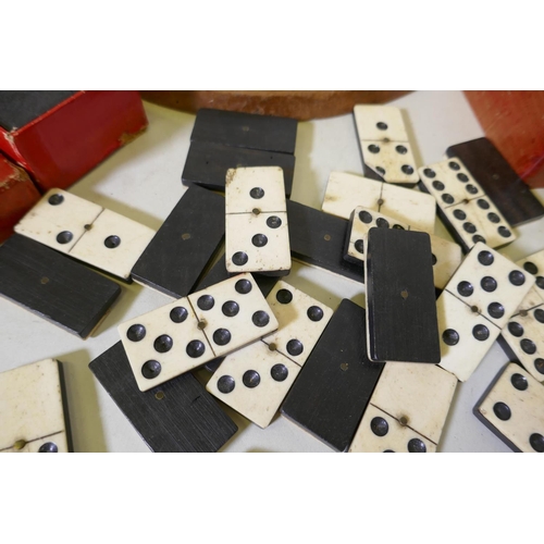 194 - An antique solitaire board with marbles and wood chess set, bone and ebony dominoes and another set