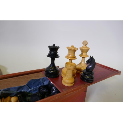 194 - An antique solitaire board with marbles and wood chess set, bone and ebony dominoes and another set