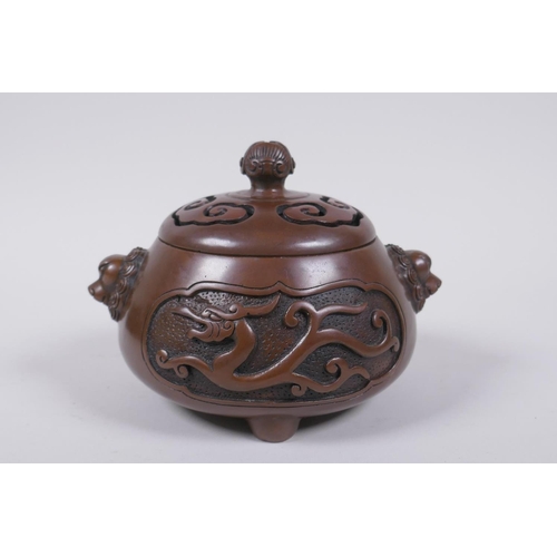 208 - A Chinese bronze censer and cover with two lion mask handles and stylised decorative dragon panels, ... 