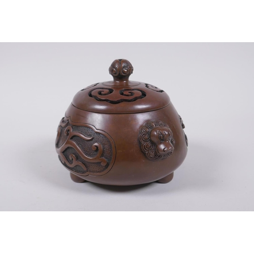 208 - A Chinese bronze censer and cover with two lion mask handles and stylised decorative dragon panels, ... 