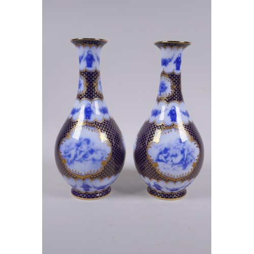 209 - A pair of continental porcelain vases with blue and white cherubic panels within within deep blue an... 