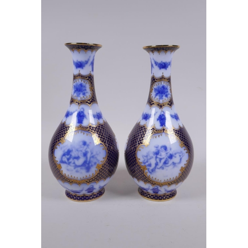 209 - A pair of continental porcelain vases with blue and white cherubic panels within within deep blue an... 