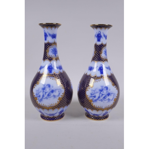 209 - A pair of continental porcelain vases with blue and white cherubic panels within within deep blue an... 