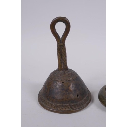 212 - An African Benin bronze bell and two bronze cash bangles, 11cm high