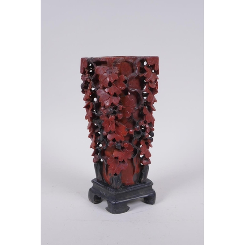 216 - A Chinese carved soapstone vase with pierced grape vine decoration, AF repair, 20cm high