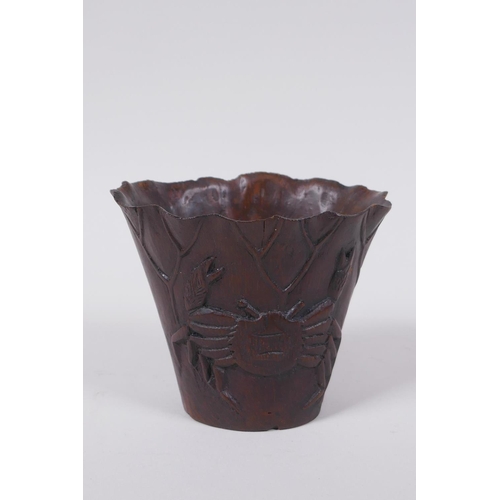 23 - An antique Chinese carved bamboo libation cup of lotus flower form with crab decoration, 8cm high