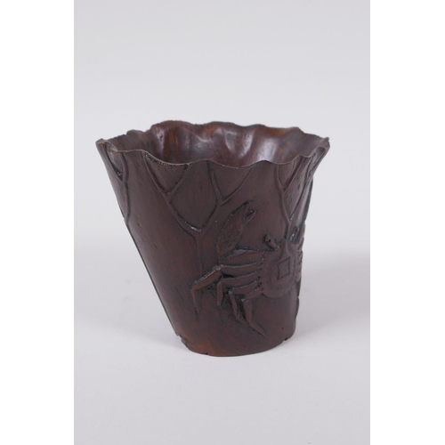 23 - An antique Chinese carved bamboo libation cup of lotus flower form with crab decoration, 8cm high