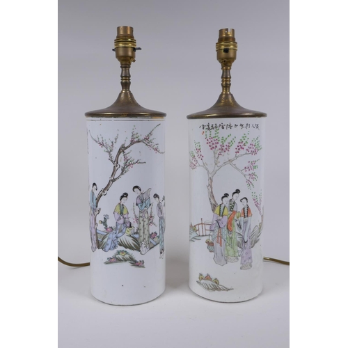 28 - A pair of Chinese Republic porcelain cylinder vases decorated with women of leisure in a garden, con... 