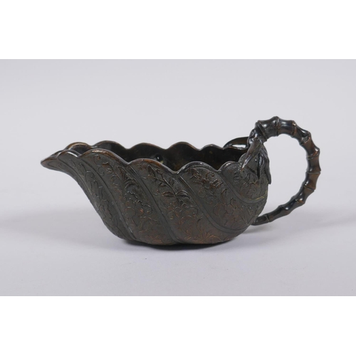 30 - A Japanese bronze bamboo and leaf shaped cup/pourer, signed to base, 15cm long