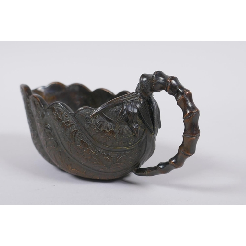 30 - A Japanese bronze bamboo and leaf shaped cup/pourer, signed to base, 15cm long