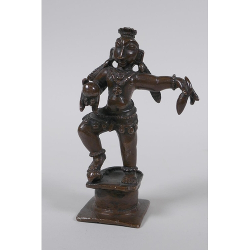 32 - An antique Indian bronze of a dancing figure, 10cm high