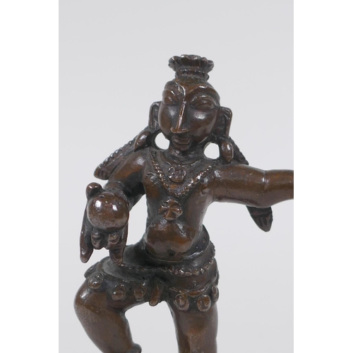 32 - An antique Indian bronze of a dancing figure, 10cm high