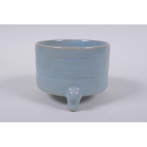 33 - A Chinese Ru ware style porcelain cylinder censer on tripod supports, 10cm diameter