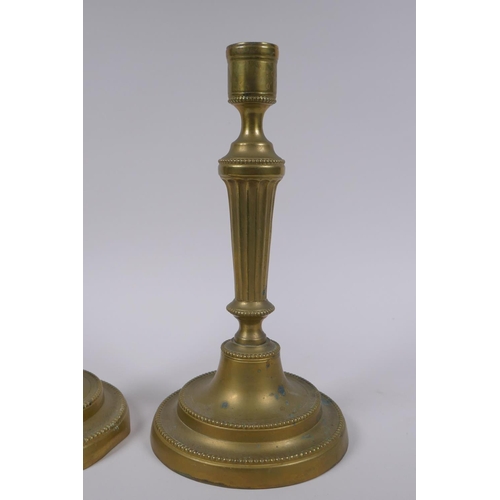 34 - A pair of antique brass column candlesticks, 25cm high