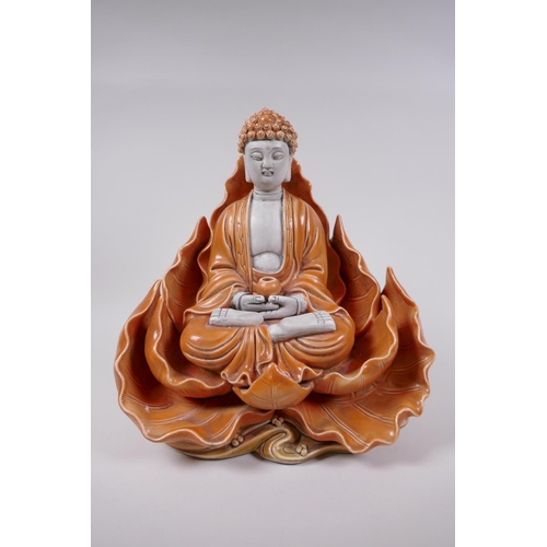 38 - A Chinese orange glazed porcelain figure of Buddha seated within a lotus flower, impressed marks ver... 