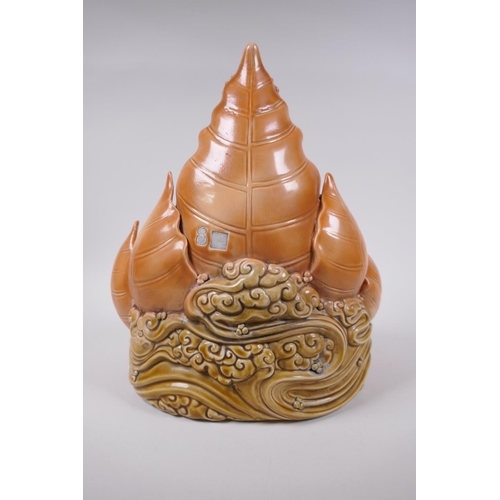 38 - A Chinese orange glazed porcelain figure of Buddha seated within a lotus flower, impressed marks ver... 