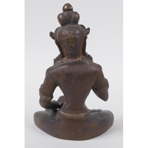 43 - An antique Tibetan bronze figure of Buddha holding a vajra and bell, 16cm high